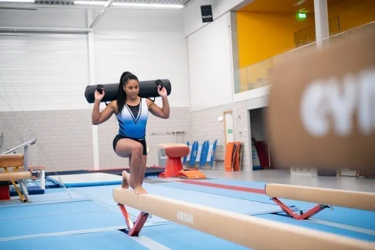 gymnast training on beam with aquabag