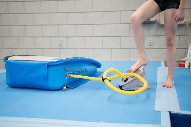 Boy pumping up AirBoard Boost with foot pump