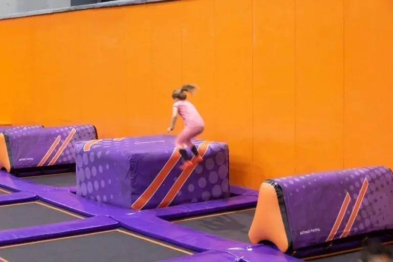 Girl jumping on AirCube in trampoline park